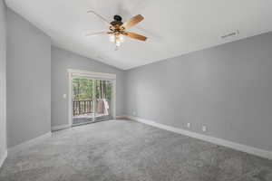 Bedroom with lofted ceiling, carpet flooring, and a ceiling fan with access to deck