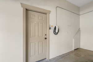 Garage entryway to private breezeway and Tesla electric vehicle charger