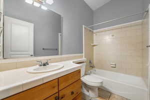 Full bathroom with bathtub / shower combination, vanity, and tile flooring