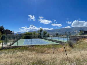 View of tennis court with a mountain view
