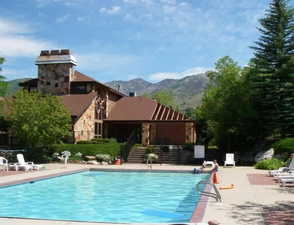 Community pool with a patio and a mountain view