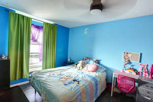 Bedroom with a textured ceiling and wood finished floors