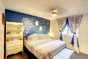 Bedroom with dark wood-type flooring