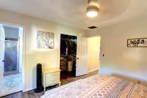 Bedroom featuring wood finished floors, a closet, and ceiling fan