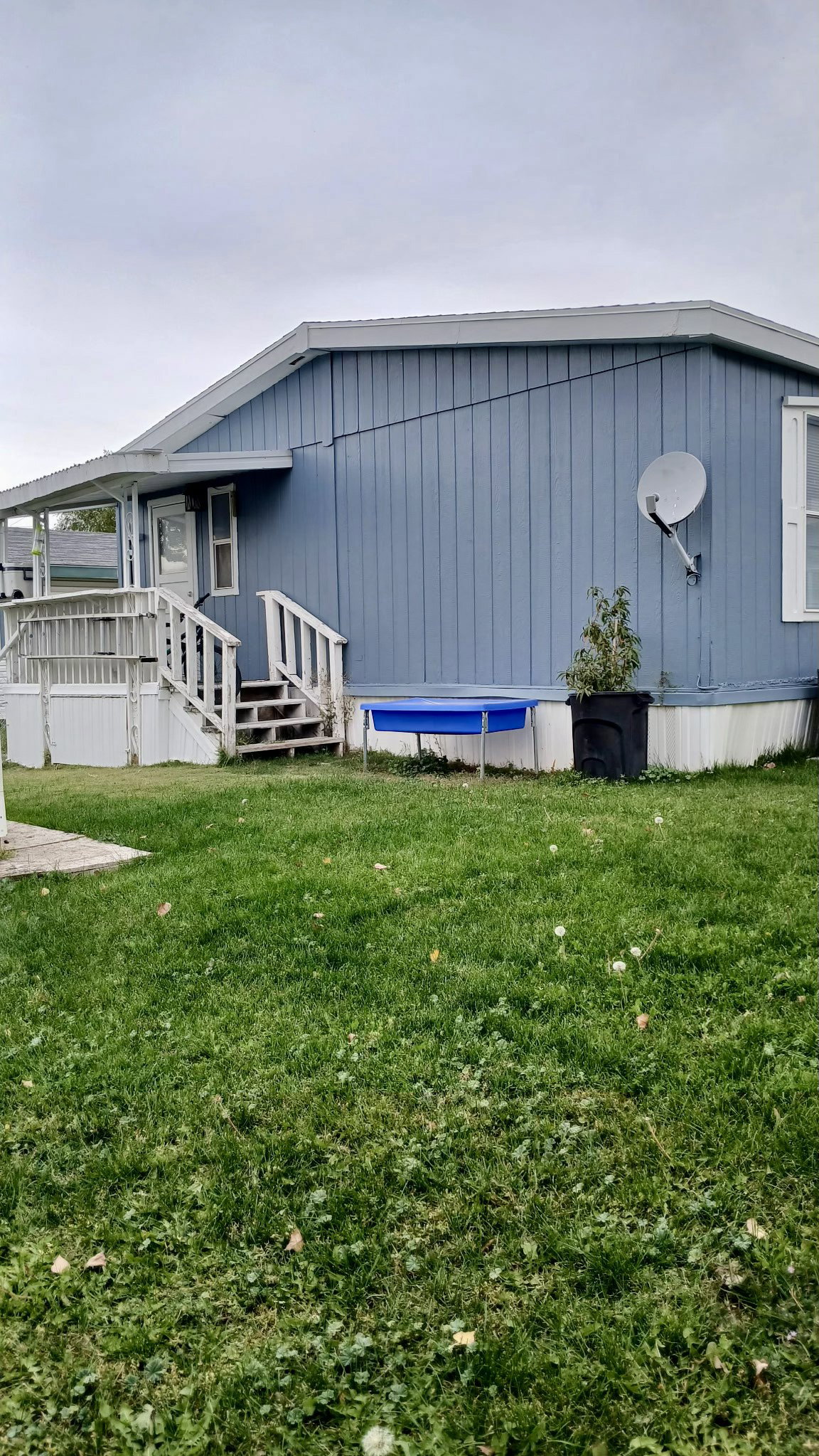 View of home's exterior with a lawn and a back deck