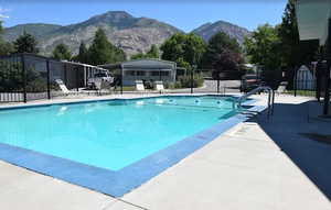Community pool featuring a patio and a mountain view