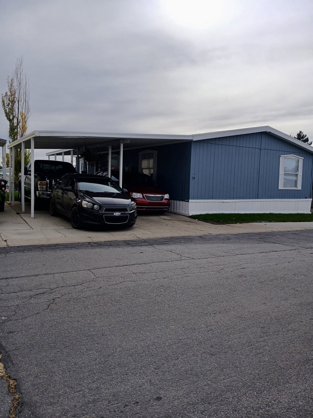 View of building exterior with an attached carport and driveway