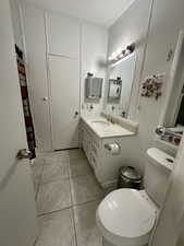 Full bath featuring vanity, a shower with curtain, a textured ceiling, and light tile patterned floors