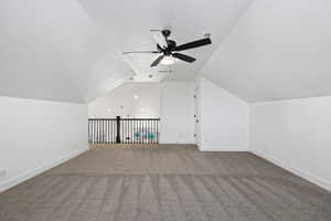 Additional living space with lofted ceiling, a textured ceiling, carpet floors, and a ceiling fan