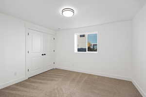 Unfurnished bedroom with carpet and a closet