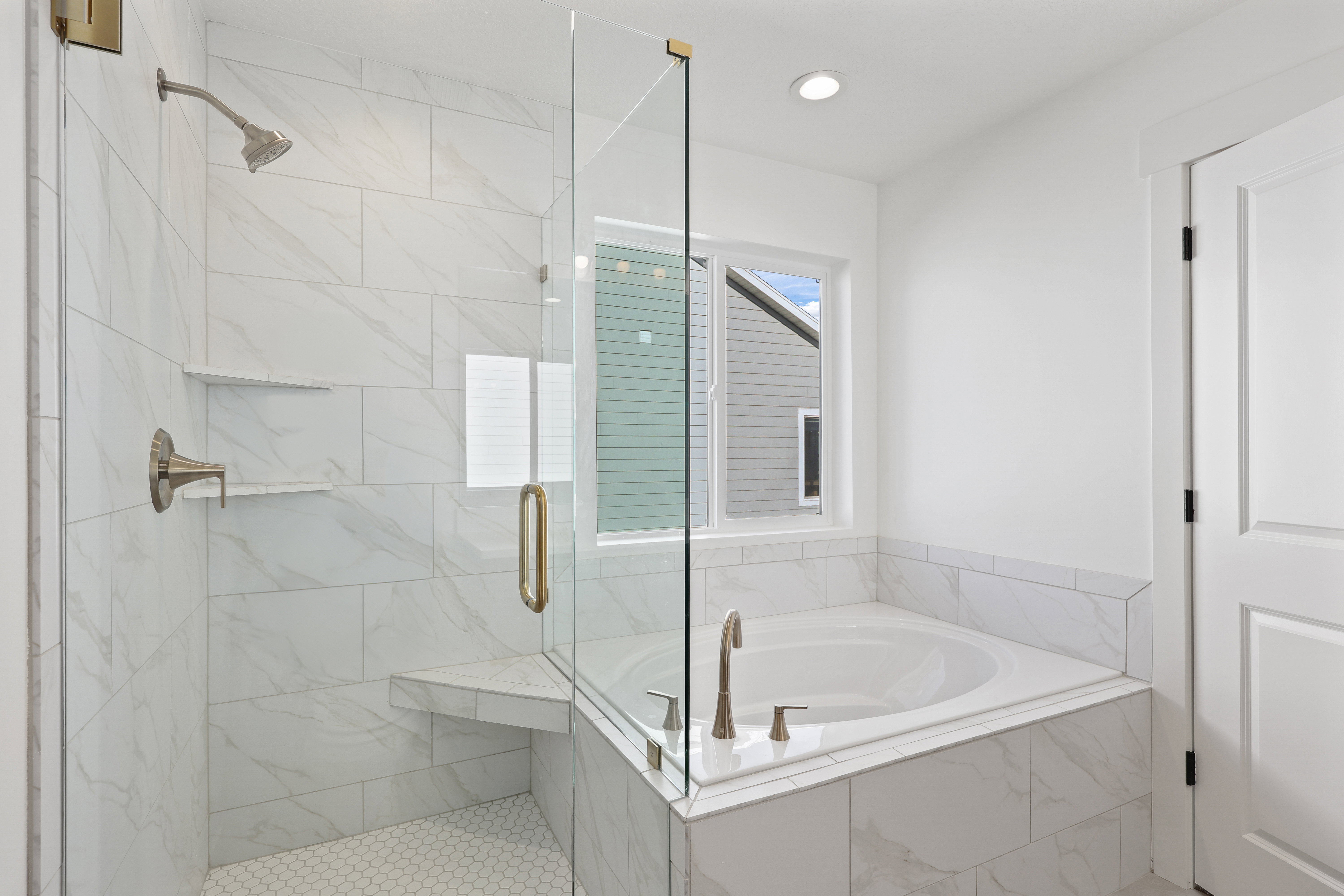 Full bath featuring a bath, a marble finish shower, and recessed lighting