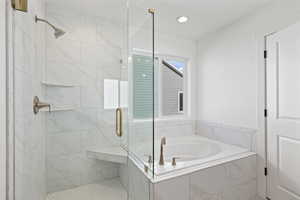 Full bath featuring a bath, a marble finish shower, and recessed lighting