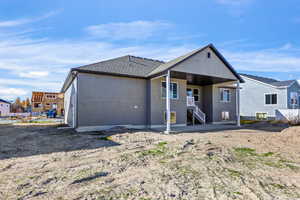 Back of house with a patio, a shingled roof, and stucco siding