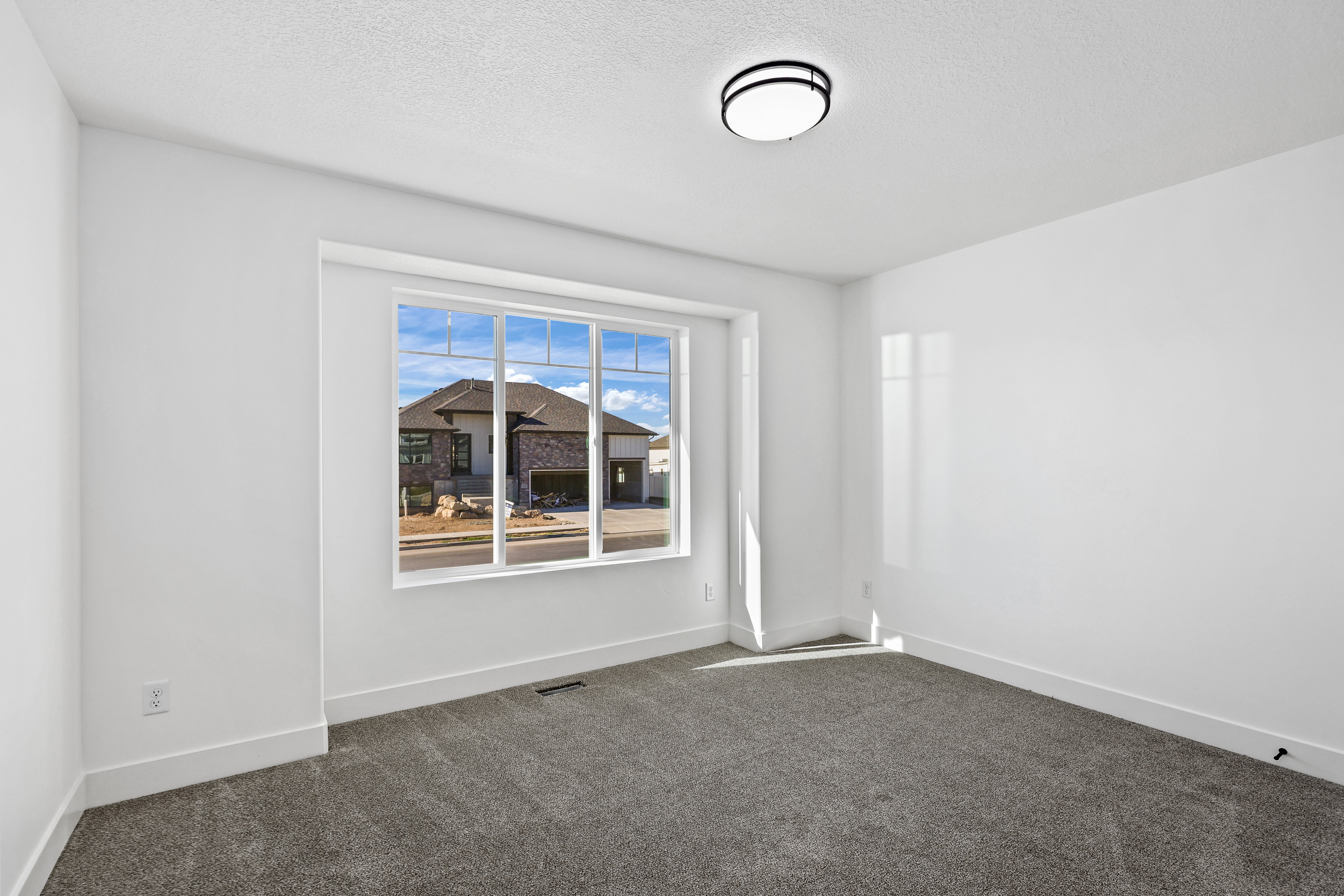 Empty room featuring carpet floors and a textured ceiling