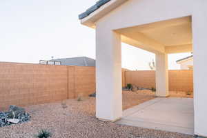 Fenced backyard with a patio area