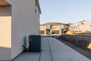 View of side of home with a residential view, stucco siding, and a mountain view