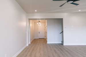 Unfurnished room with recessed lighting, light wood finished floors, a chandelier, and ceiling fan