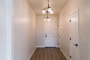 Doorway to outside featuring wood finished floors and baseboards
