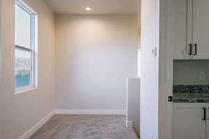 Unfurnished dining area with carpet floors and recessed lighting
