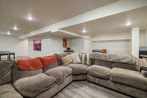 Living area featuring light wood-style floors and recessed lighting