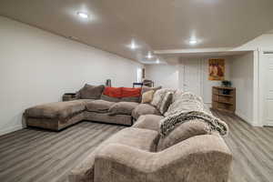 Living area featuring light wood-style floors and recessed lighting