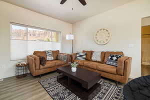 Living room with wood finished floors and a ceiling fan
