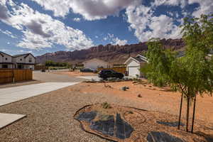 View of yard featuring a mountain view, driveway, and a garage