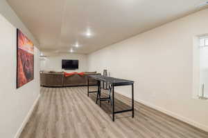 Living room with light wood-style floors and baseboards