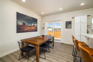 Dining area featuring light wood-style flooring and recessed lighting