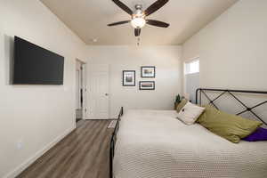 Bedroom featuring dark wood-type flooring and a ceiling fan