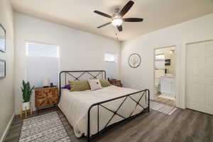 Bedroom featuring dark wood-style floors, multiple windows, and a ceiling fan
