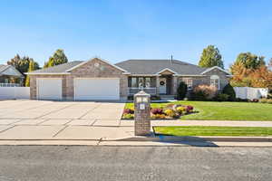 Ranch-style home with concrete driveway, a garage, roof with shingles, brick siding, and covered porch