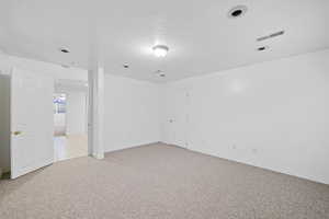 Spare room with light carpet and baseboards