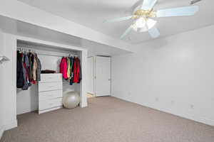Unfurnished bedroom featuring carpet flooring, a closet, and ceiling fan