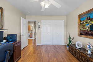 Office area featuring light wood finished floors and a ceiling fan