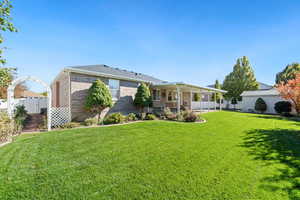 Rear view of house with brick siding and a sunroom