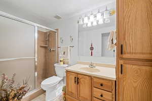 Bathroom featuring vanity, a stall shower, and light tile patterned floors