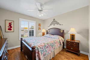 Bedroom with wood finished floors and ceiling fan