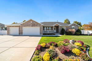 Ranch-style house featuring driveway, a garage, roof with shingles, brick siding, and a porch