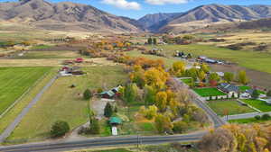 Aerial overview of property's location featuring a mountain backdrop and rural landscape