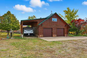 Garage featuring driveway and a garage
