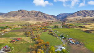 Aerial view of sparsely populated area featuring a mountain backdrop and agricultural land