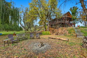 View of yard with a fire pit and stairs