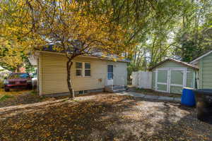 Rear view of house featuring a storage shed