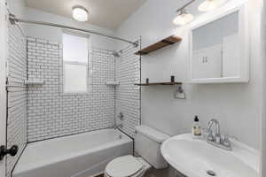 Full bath featuring shower / washtub combination and toilet