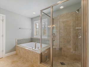 Bathroom featuring a shower stall, a garden tub, tile patterned floors, and recessed lighting
