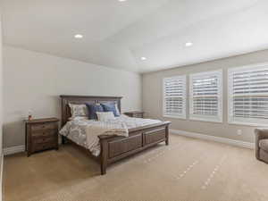 Bedroom featuring carpet floors, lofted ceiling, and recessed lighting