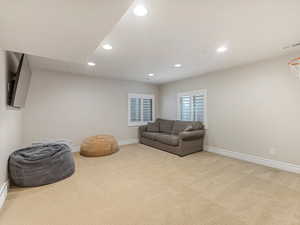 Living area featuring recessed lighting and light carpet