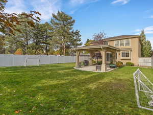 Fenced backyard with a patio area and a gazebo