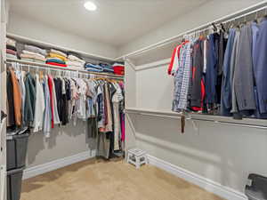Walk in closet with light carpet